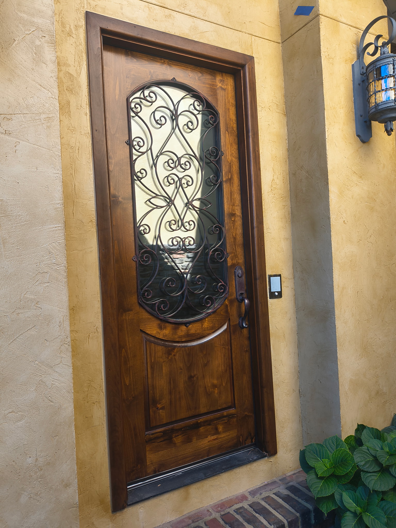 Restored wood entry door with decorative iron glass